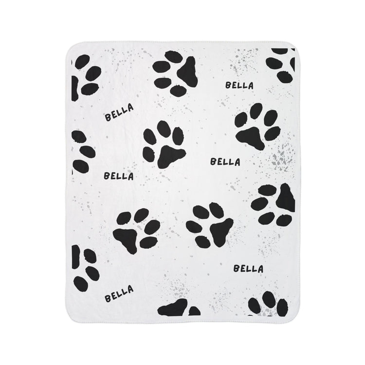 White blanket with black paw prints and &