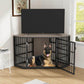 Dog inside a black metal crate in a living room with a TV above it