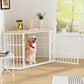 Dog inside a white metal pet gate in a room with wooden floor and large window.